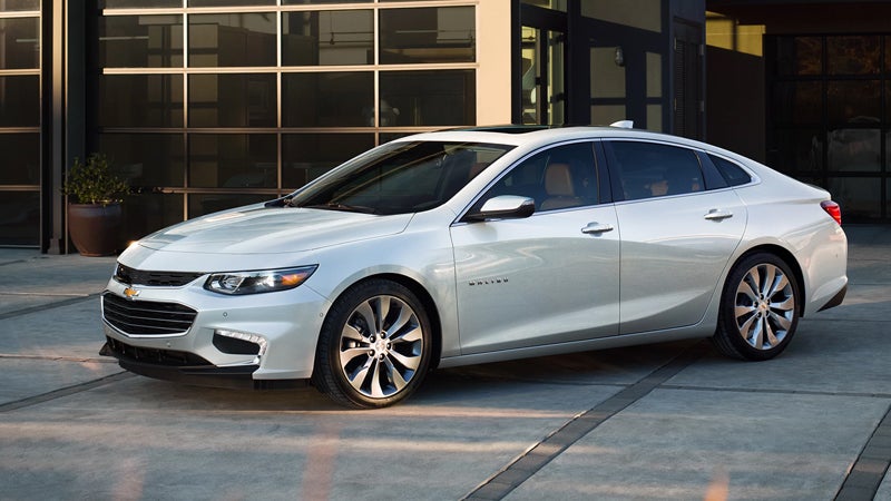 white 2018 Chevrolet Malibu standing near house